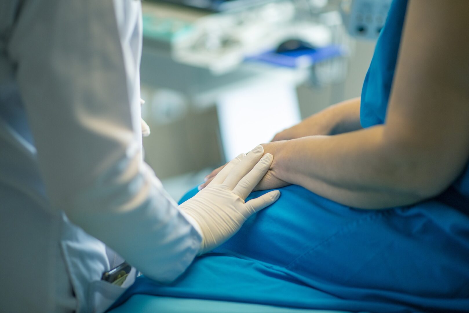 A doctor is examining a patient's hand.