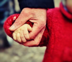 A man holding a child's hand.