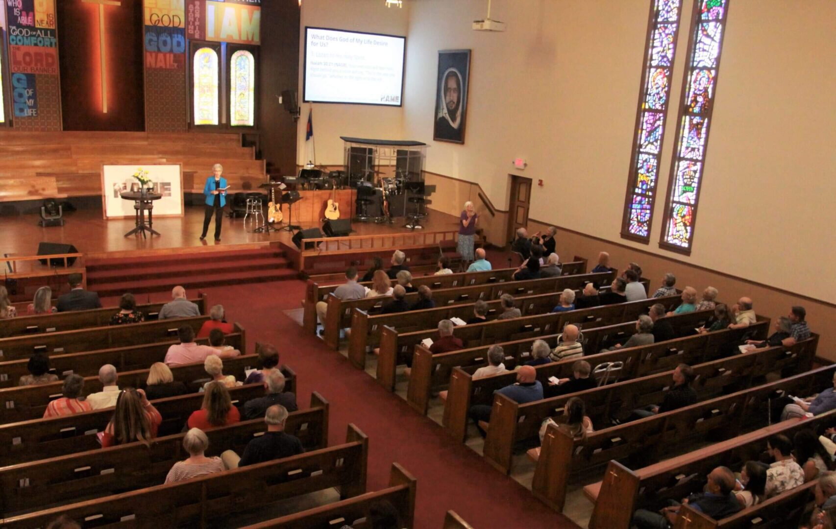 A church with many people sitting in pews.