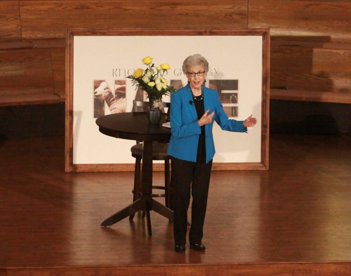 A woman giving a speech on a stage.