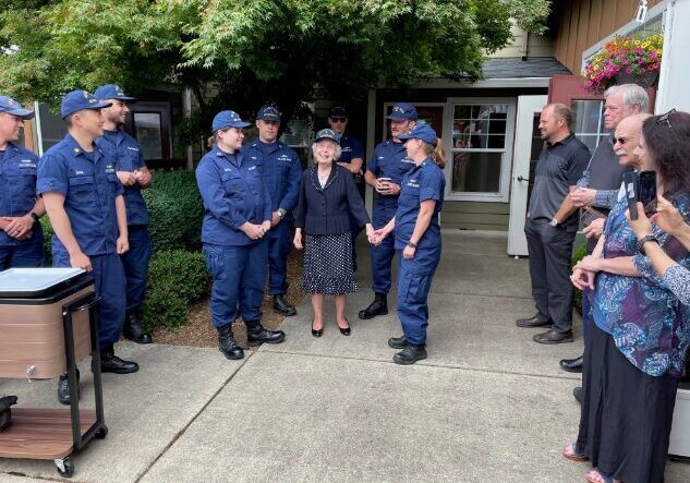 Group of uniformed personnel with a woman.